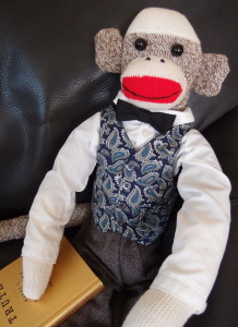 Sir Rudyard S Monkey in his favorite reading chair reading "On Truth".