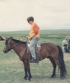 Pat Schaffer riding a horse in Mongolia