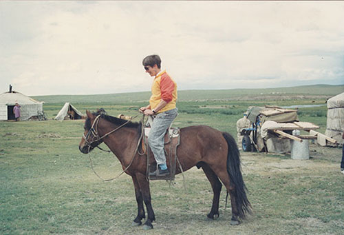 Pat Schaffer riding a horse in Mongolia